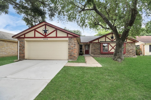 tudor home featuring a garage and a front yard