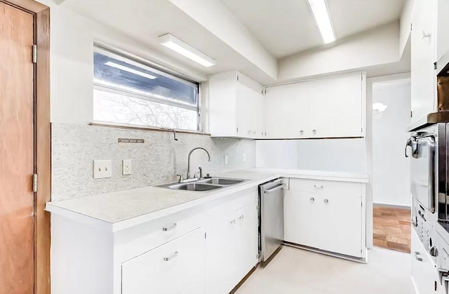 4600 Lakeshore Dr, Port Arthur, TX 77642 - kitchen featuring sink, white cabinetry, appliances with stainless steel finishes, light parquet flooring, and decorative backsplash