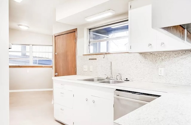 kitchen with sink, dishwasher, white cabinets, and backsplash