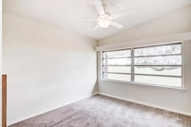 spare room featuring a wealth of natural light, carpet floors, and ceiling fan