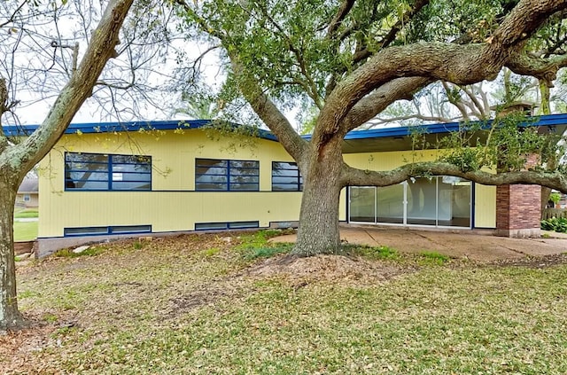 rear view of house with a yard