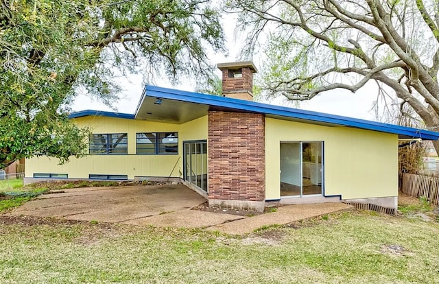 rear view of property featuring a yard