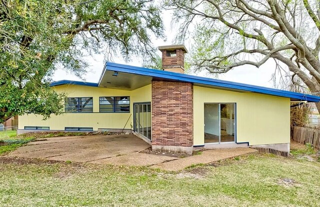 4600 Lakeshore Dr, Port Arthur, TX 77642 - rear view of property with a patio and a lawn
