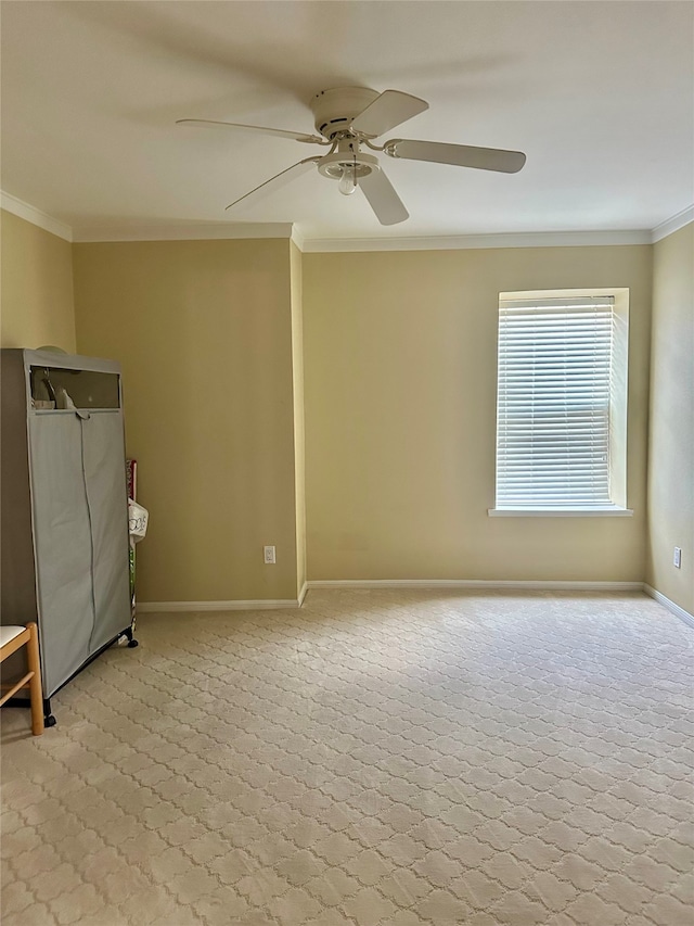 spare room with ceiling fan, carpet floors, and crown molding