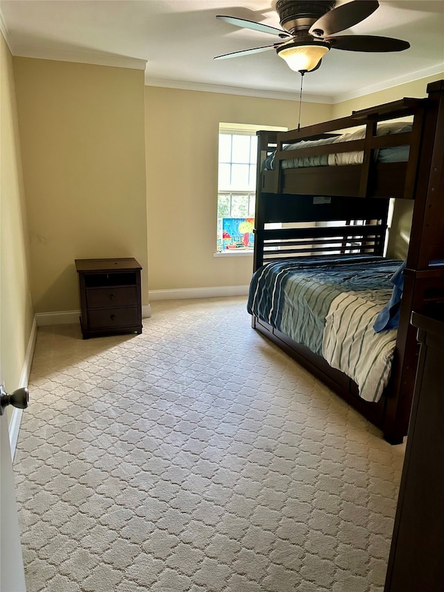 bedroom featuring ceiling fan, crown molding, and light colored carpet