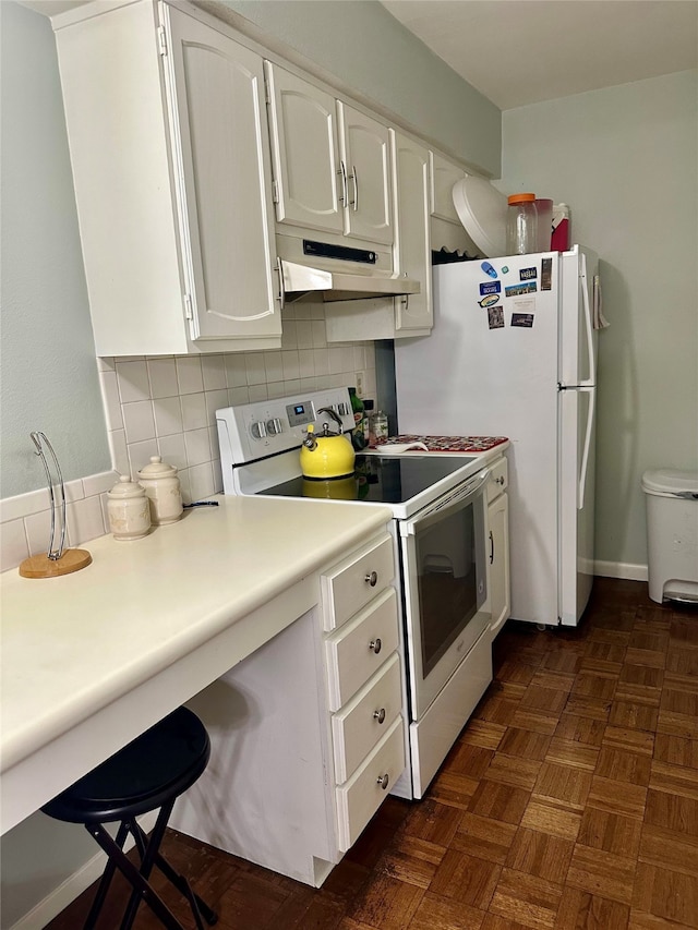 kitchen with white cabinets, white electric range oven, dark parquet flooring, and tasteful backsplash