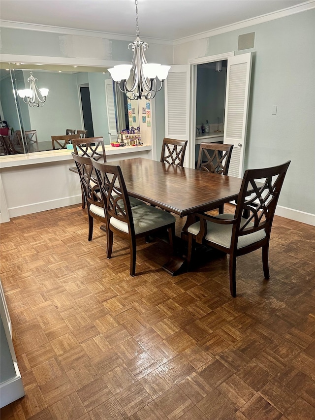 dining area featuring crown molding, parquet floors, and an inviting chandelier