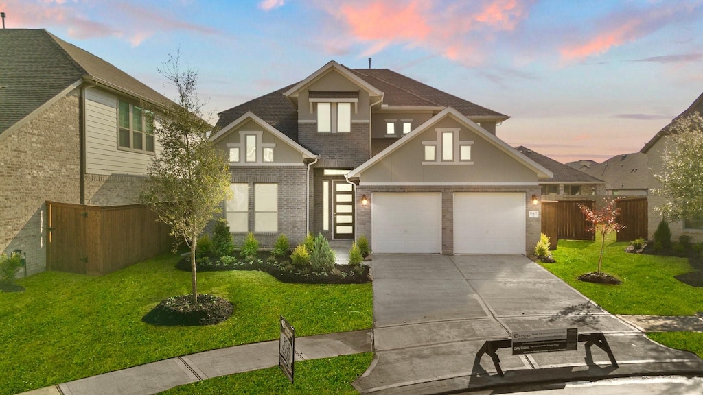 view of front of home featuring a lawn and a garage