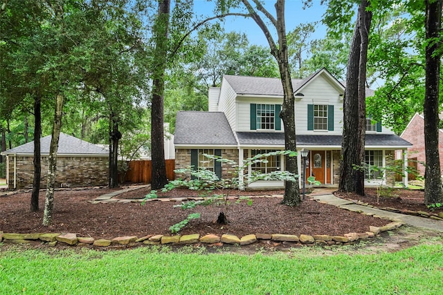 view of front facade with covered porch and a front lawn