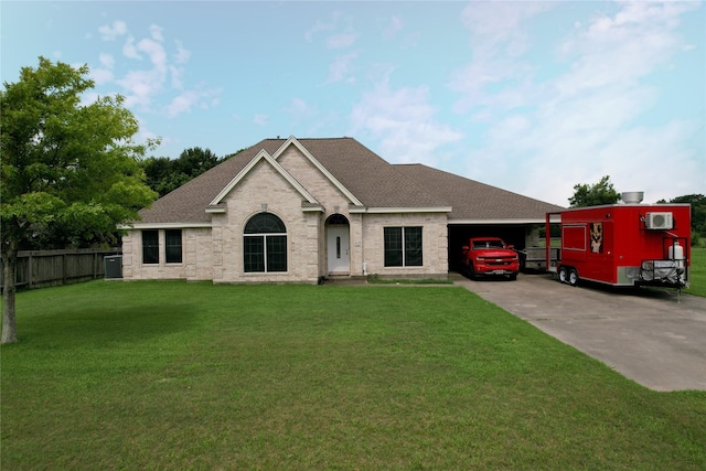 view of front of home with a front yard and a carport