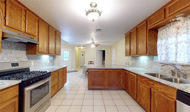 kitchen with tasteful backsplash, kitchen peninsula, sink, and appliances with stainless steel finishes