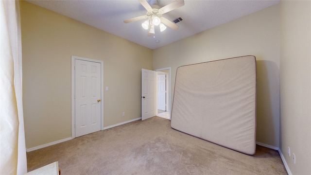 unfurnished bedroom with ceiling fan and light colored carpet