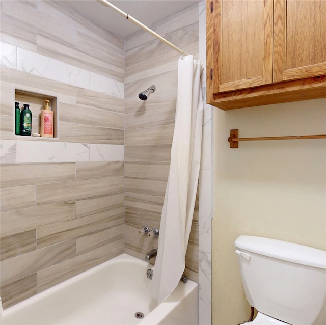 bathroom with shower / tub combo and toilet