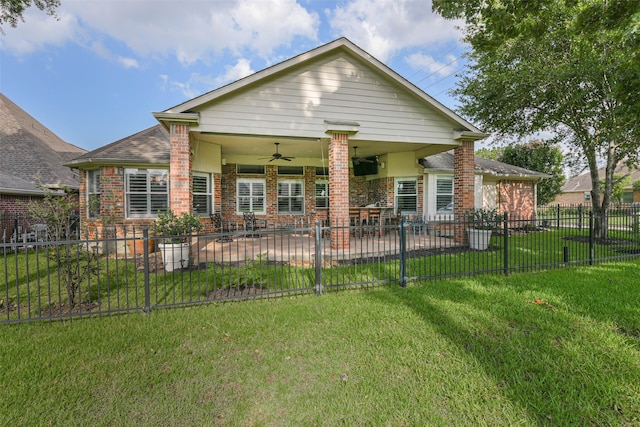 back of property featuring a patio area, ceiling fan, and a yard