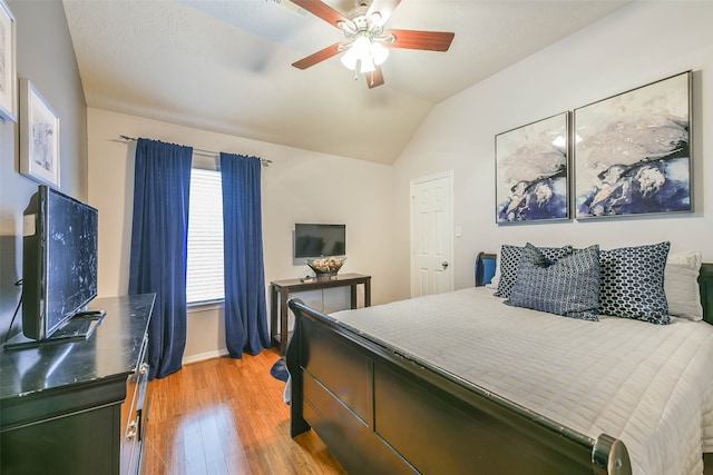 bedroom with hardwood / wood-style floors, ceiling fan, and lofted ceiling