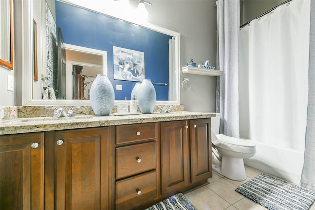 bathroom featuring tile patterned flooring, vanity, and toilet