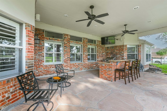 view of patio with ceiling fan and exterior bar