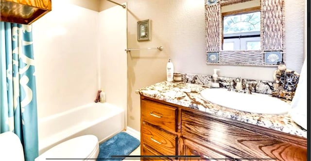 full bathroom featuring shower / tub combo, toilet, and vanity