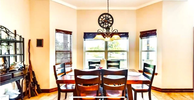 dining area with ornamental molding and a chandelier