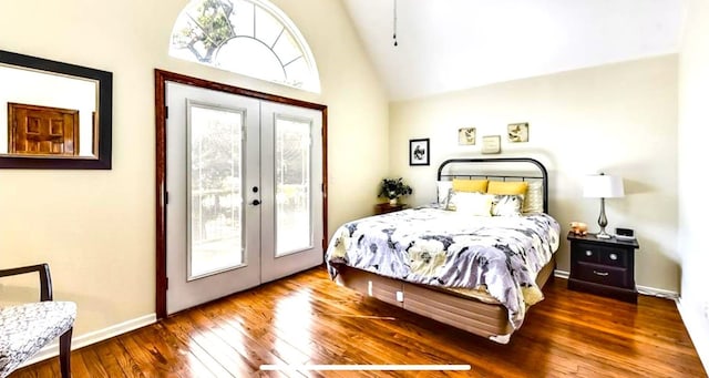 bedroom featuring multiple windows, french doors, and hardwood / wood-style flooring