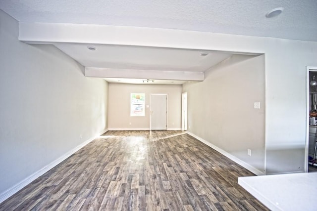 10434 S Burman St, Houston, TX 77029 - empty room featuring wood finished floors, baseboards, a textured ceiling, and beam ceiling