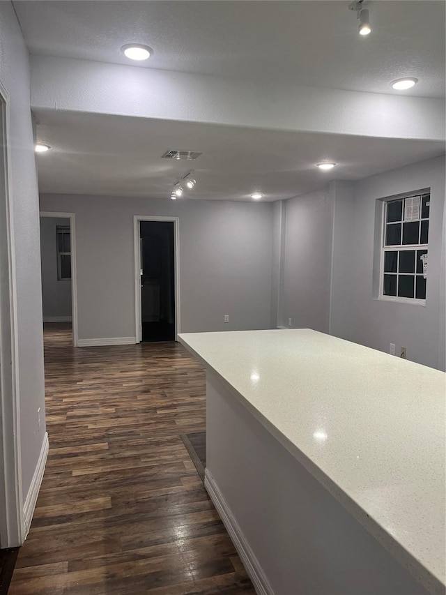 10434 S Burman St, Houston, TX 77029 - hall with baseboards, dark wood-type flooring, recessed lighting, and rail lighting