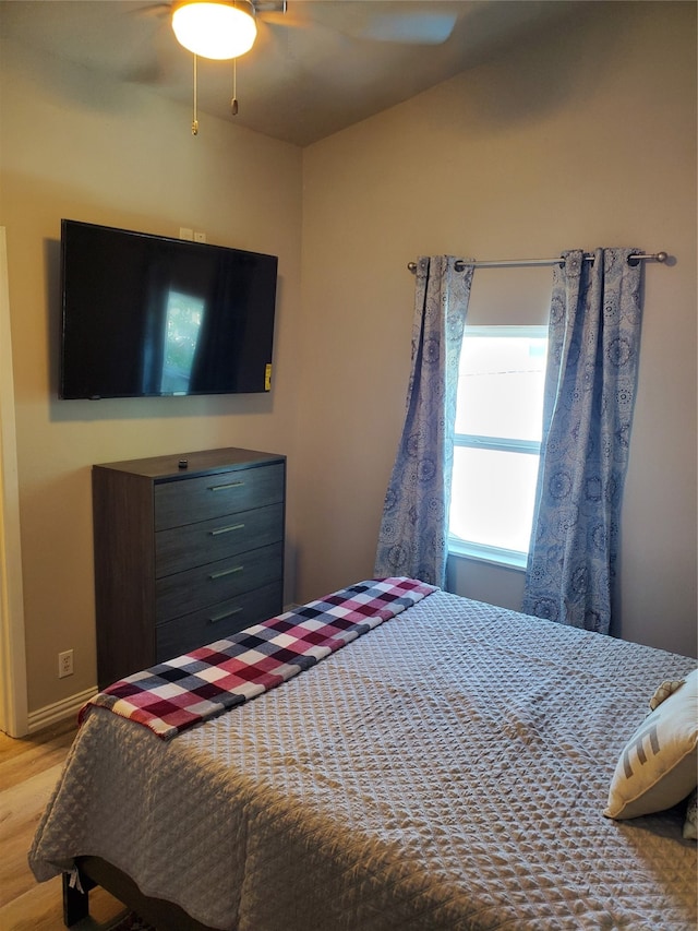 bedroom with ceiling fan and light hardwood / wood-style flooring