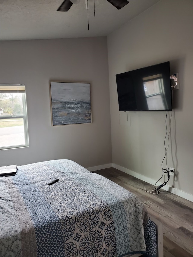 bedroom with ceiling fan and hardwood / wood-style floors