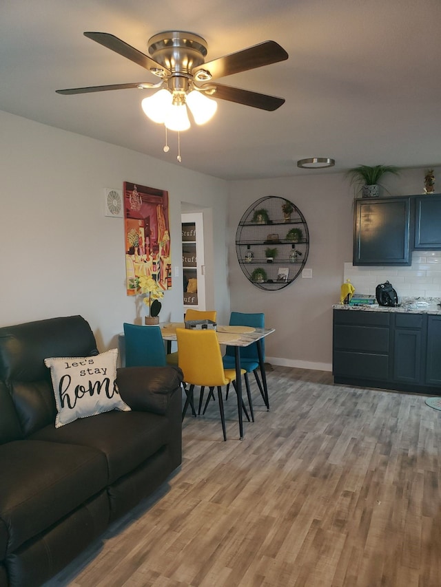 living room featuring ceiling fan and light hardwood / wood-style floors