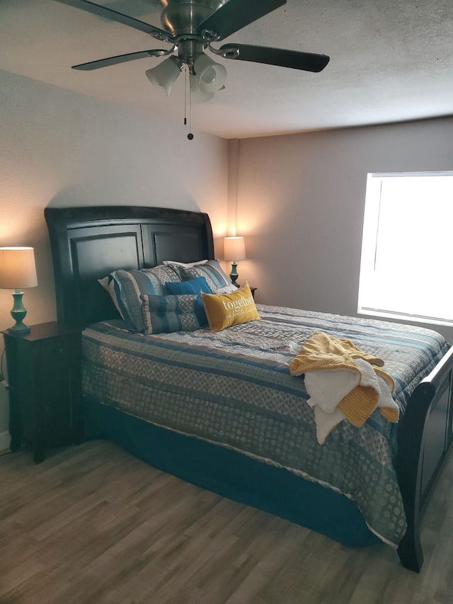 bedroom featuring hardwood / wood-style floors and ceiling fan