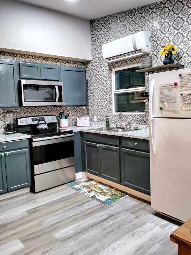 kitchen featuring stainless steel appliances, tasteful backsplash, and light wood-type flooring