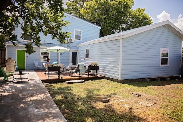 rear view of house with a lawn and a deck