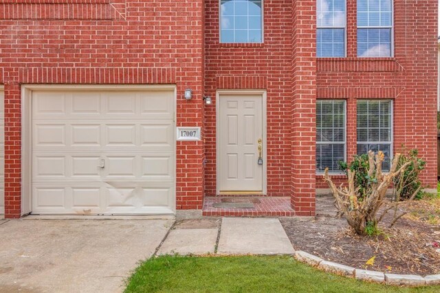 view of exterior entry with a garage