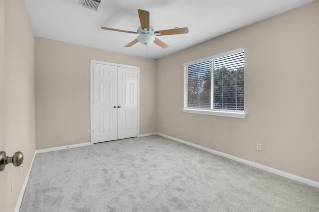 carpeted empty room with ceiling fan