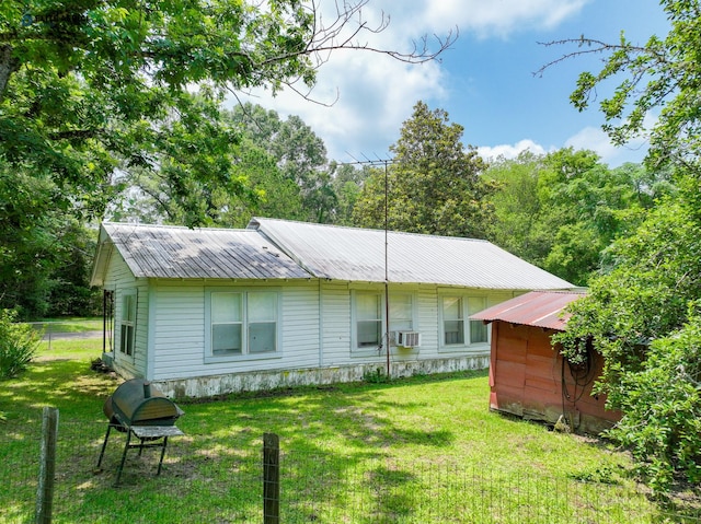 894 County Road 144, Jasper, TX 75951 - rear view of house featuring a lawn, a storage unit, and cooling unit