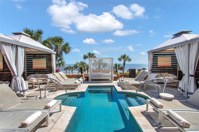 view of swimming pool featuring a gazebo and a water view