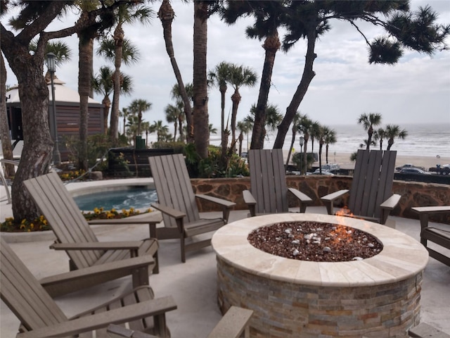 view of patio / terrace with a water view and an outdoor fire pit