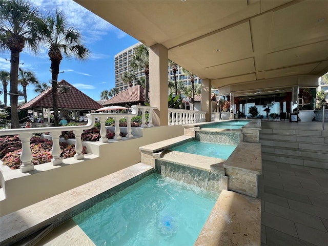 view of swimming pool with an in ground hot tub and a gazebo