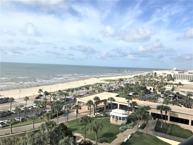 birds eye view of property with a water view and a beach view