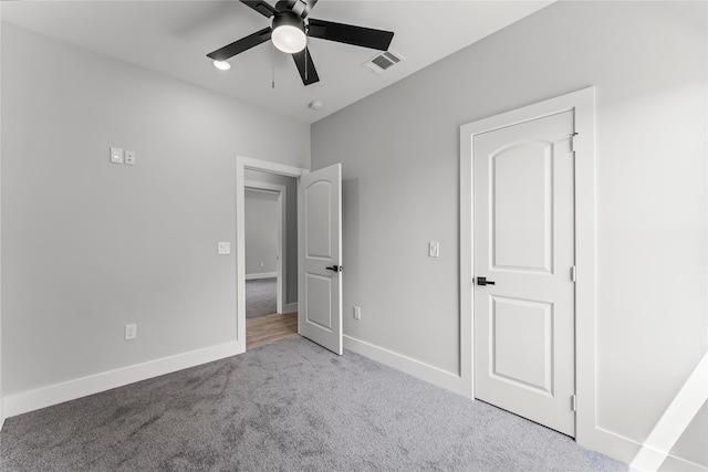 unfurnished bedroom with ceiling fan and light colored carpet