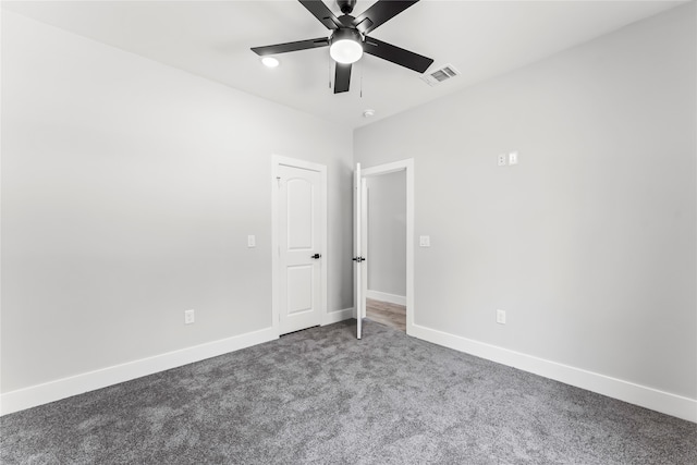 spare room featuring carpet and ceiling fan