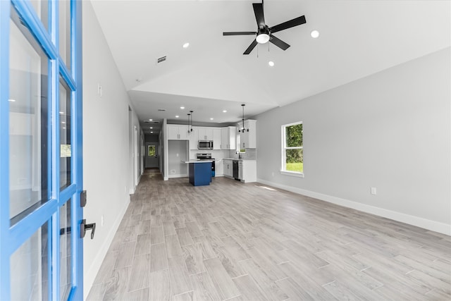 unfurnished living room featuring light wood-type flooring, high vaulted ceiling, and ceiling fan