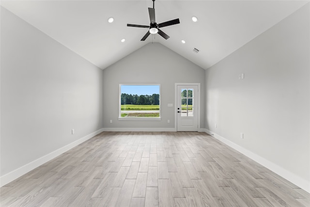 unfurnished living room with ceiling fan, light wood-type flooring, and high vaulted ceiling