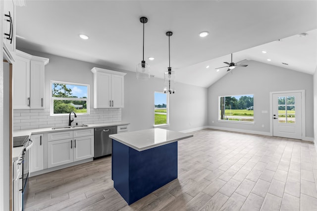 kitchen with white cabinets, a kitchen island, sink, and stainless steel appliances