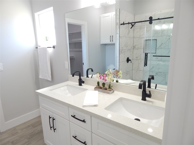 bathroom featuring vanity, a shower with shower door, and hardwood / wood-style flooring