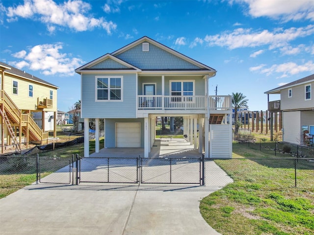 view of front of home featuring a garage, a front yard, a carport, and covered porch