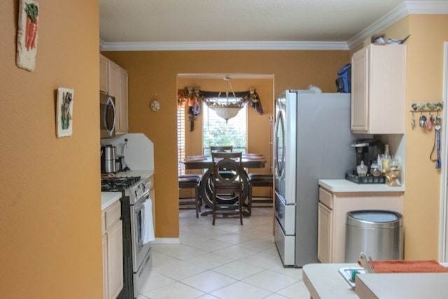 kitchen with crown molding, light tile patterned flooring, and appliances with stainless steel finishes