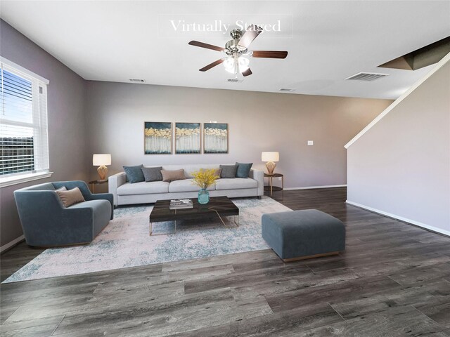 living room featuring ceiling fan and dark hardwood / wood-style flooring