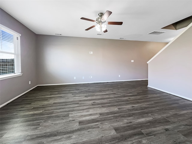 spare room featuring dark wood-type flooring and ceiling fan