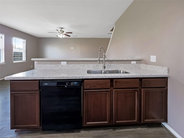 kitchen featuring sink, dark hardwood / wood-style floors, black dishwasher, dark brown cabinetry, and light stone countertops